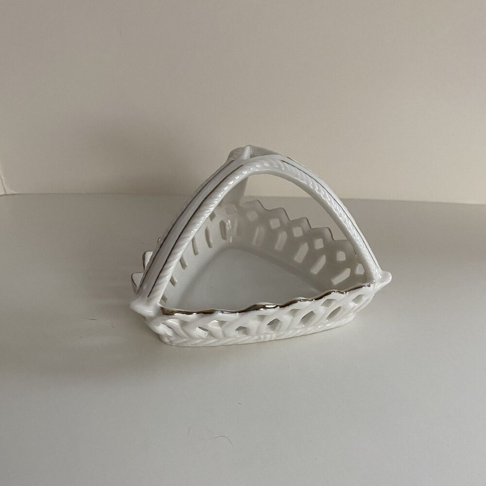 Ceramic trinket dish with gold trim 3 sided handle with lattice on the sides.